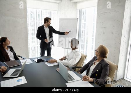 Corporate mentor, coach teaching interns at modern office meeting workspace Stock Photo