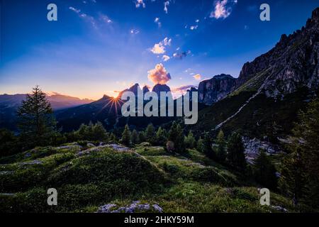 Summits of Plattkofel, Grohmannspitze and Langkofel in the middle, rock faces of Sella group on the right side, seen from Pordoi Pass at sunset. Stock Photo