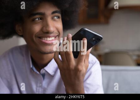 Happy teenage young guy talking on cell on speaker Stock Photo