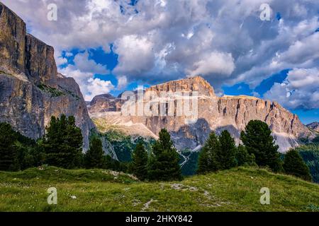 Rock faces and cliffs of Sella group, Piz Boe in the far distance, seen from below below Sella Pass. Stock Photo