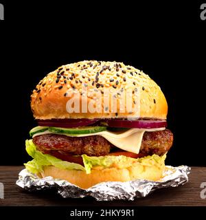 Big single cheeseburger isolated on black background Stock Photo