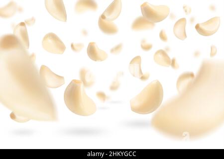 Set of peeled garlic cloves falling on a white background with selective focus. Garlic, isolated on a white background, flies down, casting a shadow. Stock Photo