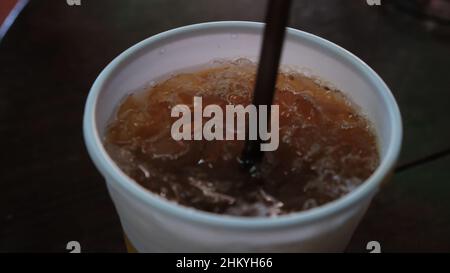 Ice Tea in a Plastic Cup with a Straw Stock Photo