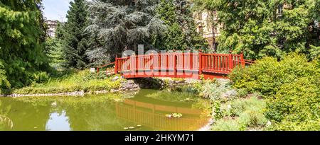 Zagreb, Croatia - August 2021. Idyllic Japanese bridge over the lake in the summer botanical garden Stock Photo