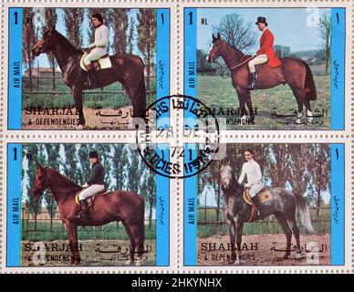 Cancelled postage stamp printed by Sharjah and dependencies, that shows Horse riding, circa 1972. Stock Photo