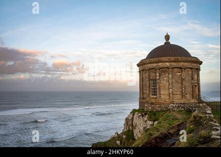 Downhill, Northern Ireland- Jan 9, 2022: the Mussenden Temple on the edge of an eroding clif on the north Coast of Ireland Stock Photo