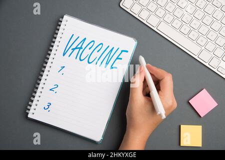 Inspiration showing sign Vaccine. Business concept Vaccine Keyboard Over A Table Beside A Notebook And Pens With Sticky Notes Stock Photo