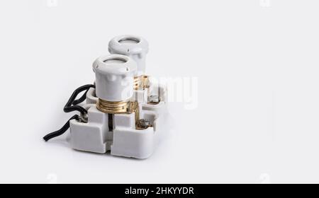 Old porcelain fuse with a holder on a white background Stock Photo