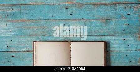 Open book with blank book pages, flat lay on wooden table. Back to school,education,reading, learning, home office concept. Free copy space Stock Photo