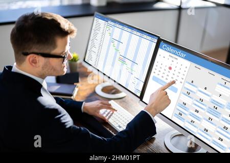 Man Working On Calendar Agenda Schedule On Computer Stock Photo