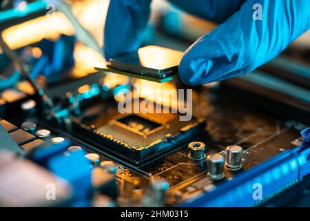 Motherboard Microchip In Hand. Computer Testing And Repair Stock Photo