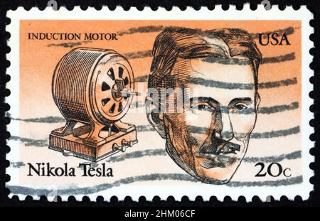 USA - CIRCA 1983: a stamp printed in the USA shows Nikola Tesla and induction motor, American inventor, circa 1983 Stock Photo