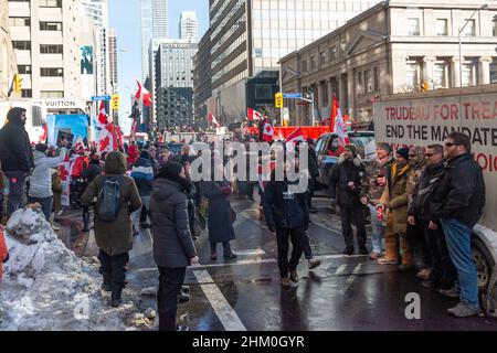 Toronto, ON, Canada – February 05, 2022:  Demonstrators gather for a protest against Covid-19 vaccine mandates and restrictions in downtown Toronto. Stock Photo