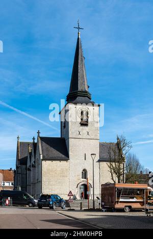 Meise, Flemish Brabant Region, Belgium - 02 05 2022: Village square with food market and a catholic church over a blue sky Stock Photo