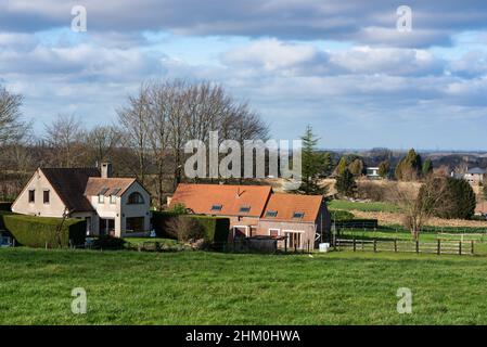 Meise, Flemish Brabant Region, Belgium - 02 05 2022: View over village urbanisation and farmland with a blue sky Stock Photo