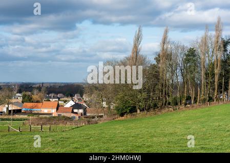 Meise, Flemish Brabant Region, Belgium - 02 05 2022: View over village urbanisation and farmland with a blue sky Stock Photo