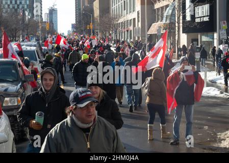 Toronto, ON, Canada – February 05, 2022:  Demonstrators gather for a protest against Covid-19 vaccine mandates and restrictions in downtown Toronto. Stock Photo