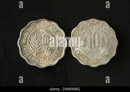 Mumbai Maharashtra India Asia March 22 2021 Indian currency Ten paise made of aluminium 1978 concept food and shelter for  all on black background. Stock Photo