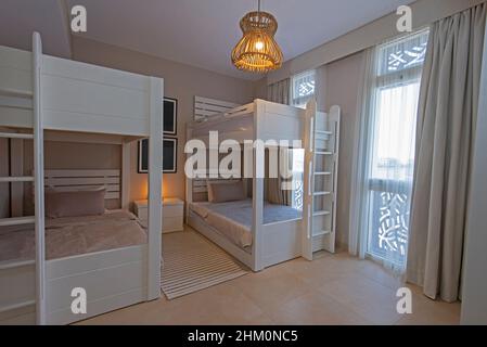 Interior design decor furnishing of luxury show home childrens bedroom showing furniture and bunk beds in resort Stock Photo