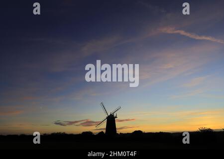 Sunset over Burnham Overy Staithe windmill, Burnham Overy Staithe village, North Norfolk Coast, England, UK Stock Photo