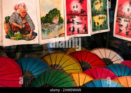 Paper parasols and paintings for sale in the night market in Luang Prabang, Laos