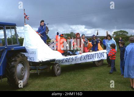 1977, historical, on the back of a tractor, brownies and girl guides in outdoor gear on a decorated parade float commerating the Everest Expedition of the same year, taking part in a village carnival to celebrate the silver jubilee of Her Majesty, Queen Elizabeth II, England, UK. Stock Photo