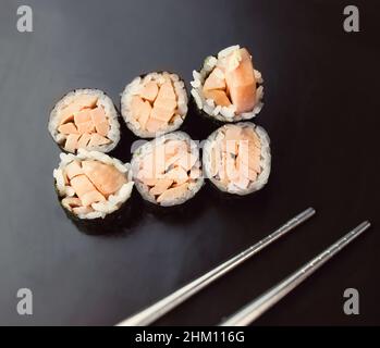 sushi rolls on the black porcelain background Stock Photo