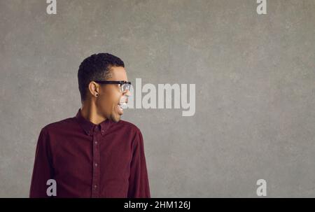 Furious angry young business man shouting and yelling Stock Photo