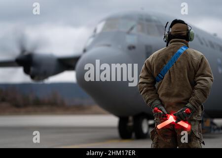 Ramstein Air Base, Germany. 06th Feb, 2022. A U.S. Air Force Airman assigned to Ramstein Air Base, Germany, marshals a C-130J Super Hercules aircraft prior to departure, February 3, 2022. A small element of 435th Contingency Response Group personnel have deployed to Poland, at their government's request, to prepare to assist humanitarian efforts resulting from a possible Russian incursion into Ukraine. Photo by Airman 1st Class Edgar Grimaldo/U.S. Air Force/UPI Credit: UPI/Alamy Live News Stock Photo