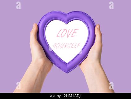 Hands holding heart with love yourself text. Self-respect and confidence concept. High quality photo Stock Photo