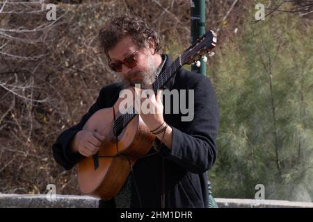 man playing the guitar on the streets of Granada Stock Photo