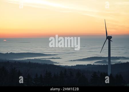 Misty inversion sunset in the hessian highlands with a windmill in the foreground Stock Photo