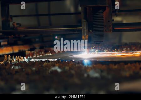 Automatic cnc laser cutting machine working with sheet metal with sparks. Metalworking industrial manufacturing factory. Stock Photo