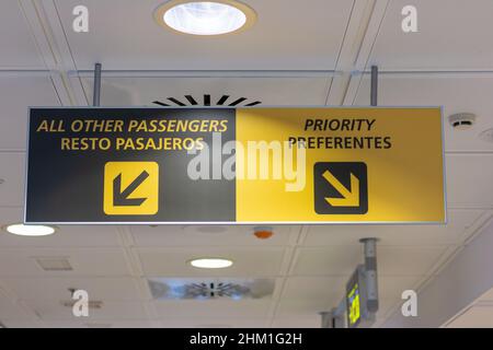 Priority and others passengers sign in english and spanish. Stock Photo