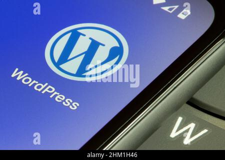 WordPress app icon is seen on the screen of a smartphone. Stock Photo