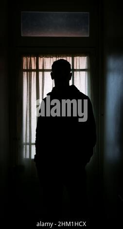 SALISBURY, UK. A man stood in the doorway of a house in Lower Bemerton, Salisbury, Wiltshire, UK. Dated: 05/02/2022. Stock Photo