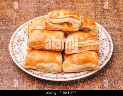 Homemade potato patties in a dish isolated on dark wooden background top view Stock Photo
