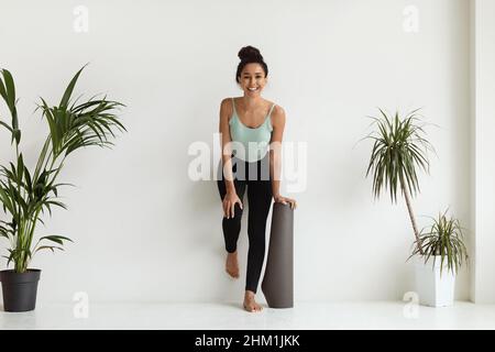 Healthy Lifestyle. Portrait Of Cheerful Woman In Activewear Posing In Yoga Studio Stock Photo