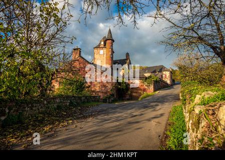 A picturesque and intricate red stone manor in Collonges-la-Rouge,  Correze, France, taken on a partly sunny autumn afternoon with no people. Stock Photo