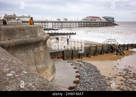 Cromer, Norfolk, UK – February 2022. Family enjoying time on Cromer beach on the North Norfolk coast on a dull and overcast winter’s day Stock Photo