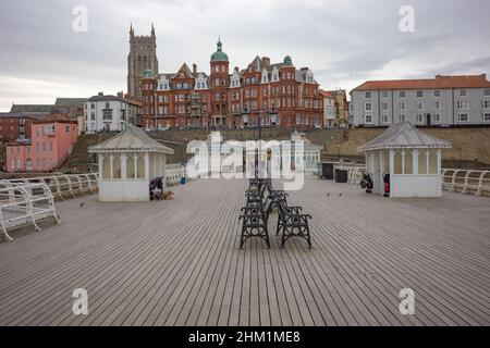 Cromer, Norfolk, UK – February 2022. A view along the Victorian Cromer pier towards the seafront and town on a dull and overcast winter’s day Stock Photo