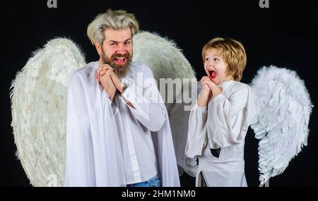 Valentines day celebration. Happy father and son angels. Cupid family with white wings. Stock Photo