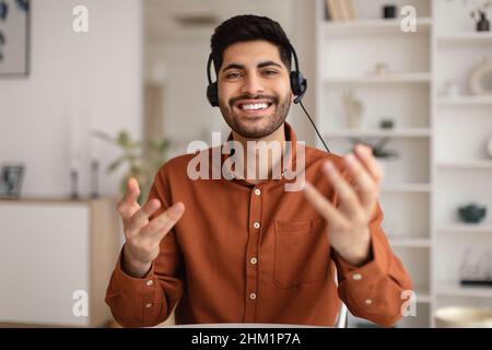 Arab man having video call and talking at webcam Stock Photo