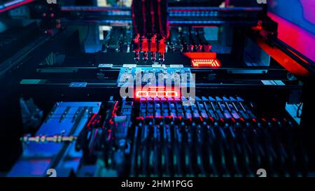 High-tech production of computer chips on automatic Pick and Place equipment. Automatic production of Computer Chips by SMT Pick and Place machine.  Stock Photo