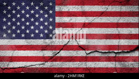 Full frame photo of a weathered American (United States of America or USA) flag painted on a cracked wall. Stock Photo