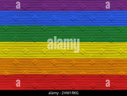 Close-up of a tablecloth in rainbow flag colors. Abstract textured background. Gay pride and LGBT movement flag concept. Stock Photo