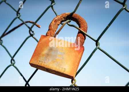 Rusty padlock on an old fence Stock Photo