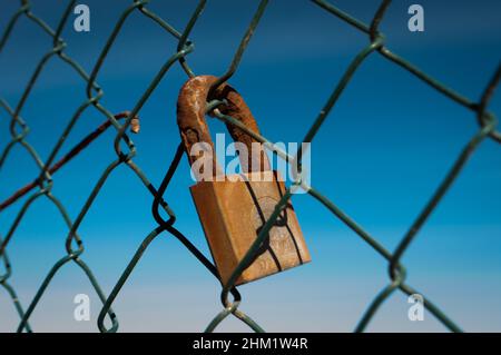 Rusty padlock on an old fence Stock Photo