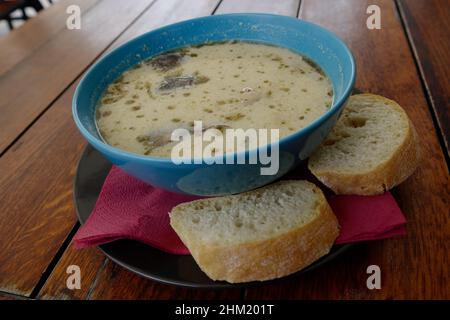 A bowl of Żurek (Polish sour rye soup) at a restaurant in the Old Town, Warsaw, Poland, August 2021 Stock Photo