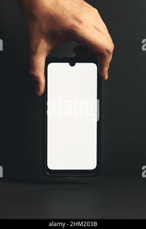 Phone Attacking Hand Dark hand of a business man grabbing for an at-sign, symbolic of ...